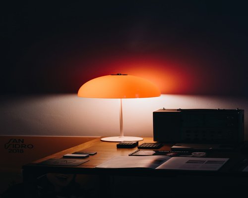 A neat desk workspace in Madrid with stationery notebooks and a pen ready to write